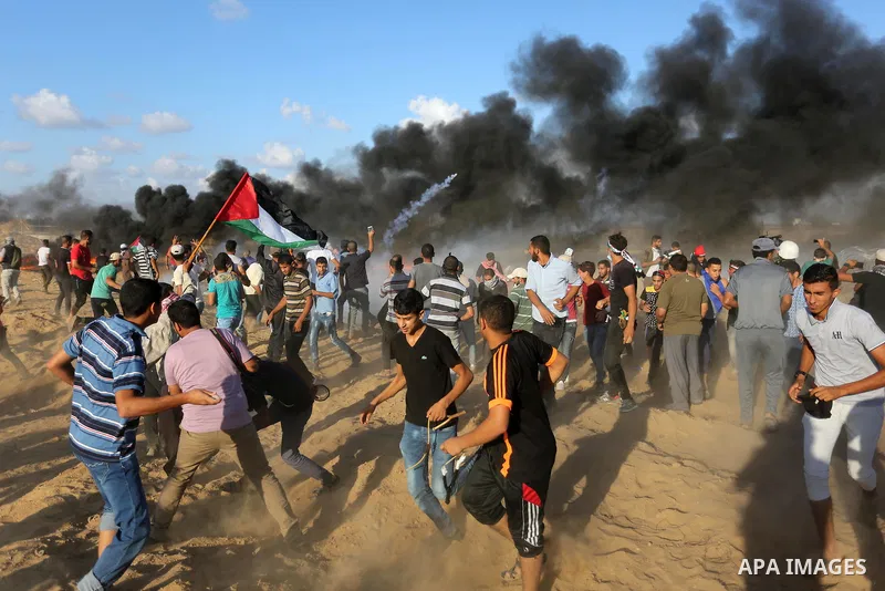 Palestinian protesters gather during clashes with Israeli troops in tents protest where Palestinians demand the right to return to their homeland at the Israel-Gaza border, in Khan Younis in the southern Gaza Strip on Se...