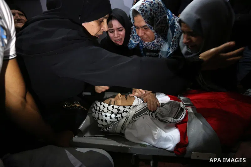 Relatives of Palestinian Belal Khafaja, 17, who was shot dead by Israeli troops during clashes in tents protest at the Israel-Gaza border, mourn next to his body during his funeral in Rafah in the southern Gaza Strip on...