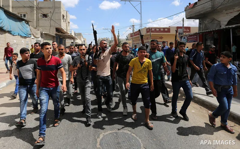 Mourners carry the body of Palestinian Belal Khafaja, 17, who was shot dead by Israeli troops during clashes in tents protest at the Israel-Gaza border, during his funeral in Rafah in the southern Gaza Strip on September...