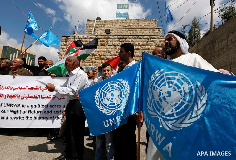 Palestinians take part during a protest against the United States decision to stop funding and backing the United Nations Relief and Works Agency (UNRWA) in the West Bank city of Hebron on September 8, 2018. The United S...