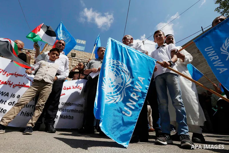 Palestinians take part during a protest against the United States decision to stop funding and backing the United Nations Relief and Works Agency (UNRWA) in the West Bank city of Hebron on September 8, 2018. The United S...