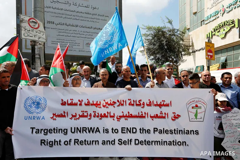 Palestinians take part during a protest against the United States decision to stop funding and backing the United Nations Relief and Works Agency (UNRWA) in the West Bank city of Hebron on September 8, 2018. The United S...