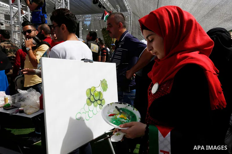 Palestinians display Grapes during the Palestinian grapes festival in Halhoul village, near the West Bank city of Hebron, on September 10, 2018. Hebron is very famous in grape production as it contains many fields of gra...