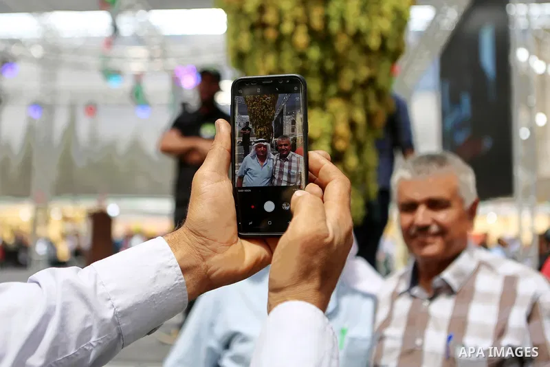 Palestinians attend the Palestinian grapes festival in Halhoul village, near the West Bank city of Hebron, on September 10, 2018. Hebron is very famous in grape production as it contains many fields of grapes, the summer...