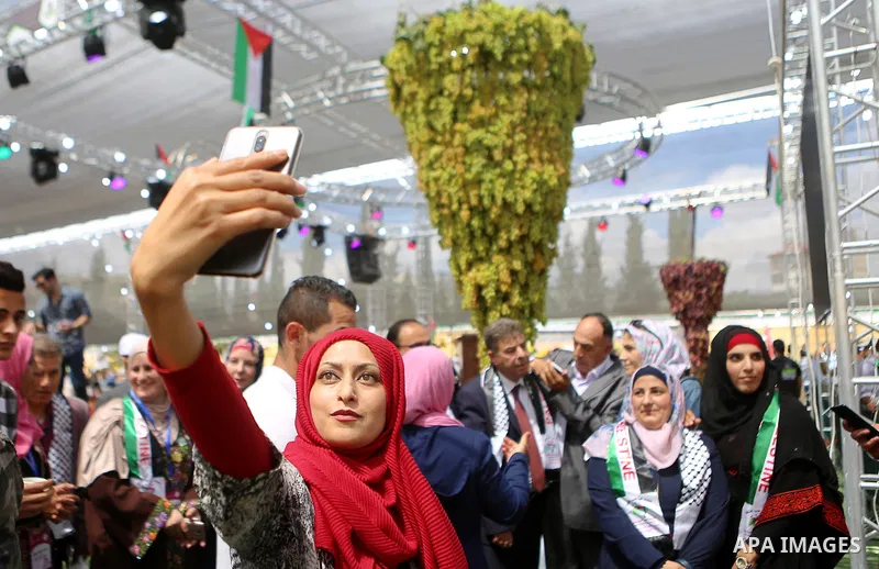 Palestinians attend the Palestinian grapes festival in Halhoul village, near the West Bank city of Hebron, on September 10, 2018. Hebron is very famous in grape production as it contains many fields of grapes, the summer...