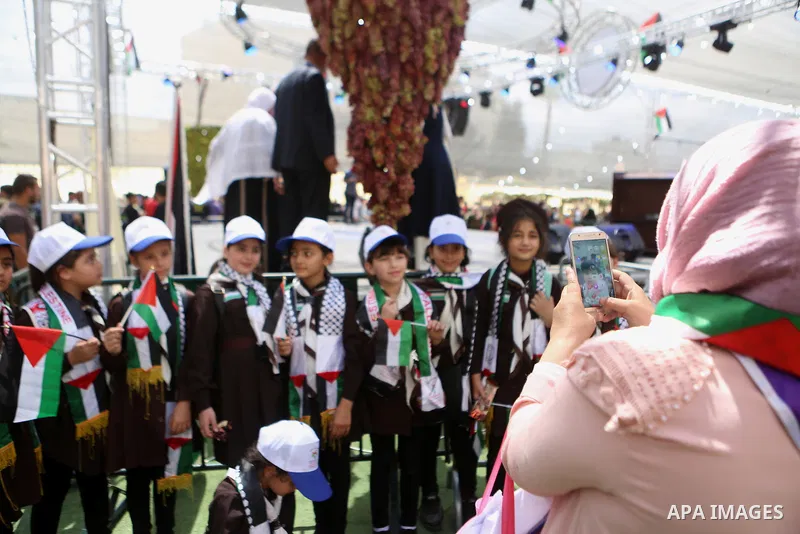 Palestinians attend the Palestinian grapes festival in Halhoul village, near the West Bank city of Hebron, on September 10, 2018. Hebron is very famous in grape production as it contains many fields of grapes, the summer...