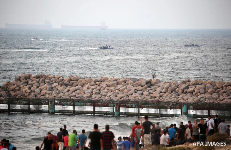 Palestinian protesters gather during a demonstration against the Israeli blockade on Gaza Strip, along the Gaza sea barrier on the maritime border with Israel near Kibbutz Zikim, north of Beit Lahia in the northern Gaza...