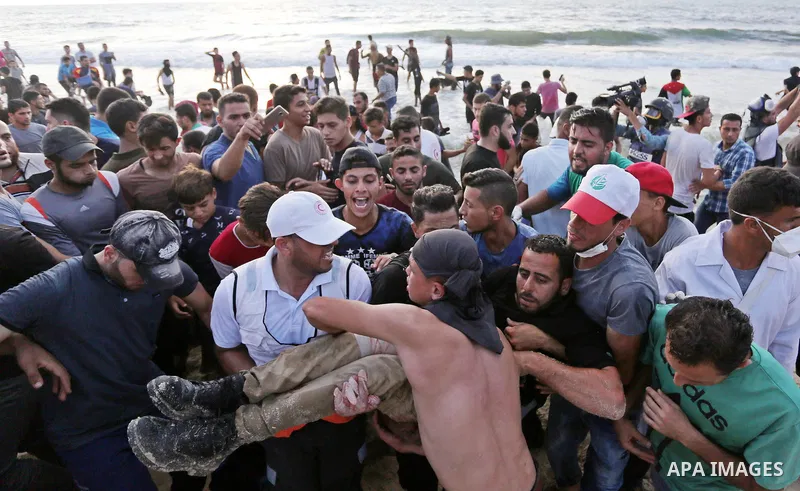 A wounded Palestinian protester is evacuated during a demonstration against the Israeli blockade on Gaza Strip, along the Gaza sea barrier on the maritime border with Israel near Kibbutz Zikim, north of Beit Lahia in the...