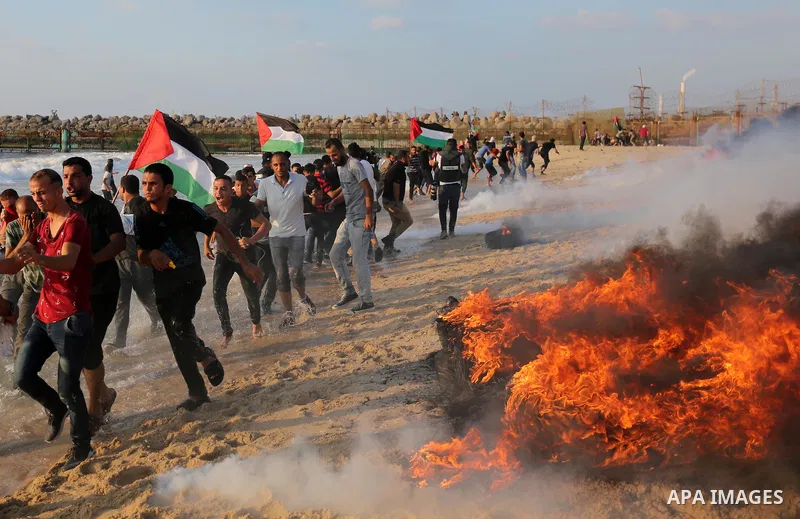 Palestinian protesters gather during a demonstration against the Israeli blockade on Gaza Strip, along the Gaza sea barrier on the maritime border with Israel near Kibbutz Zikim, north of Beit Lahia in the northern Gaza...
