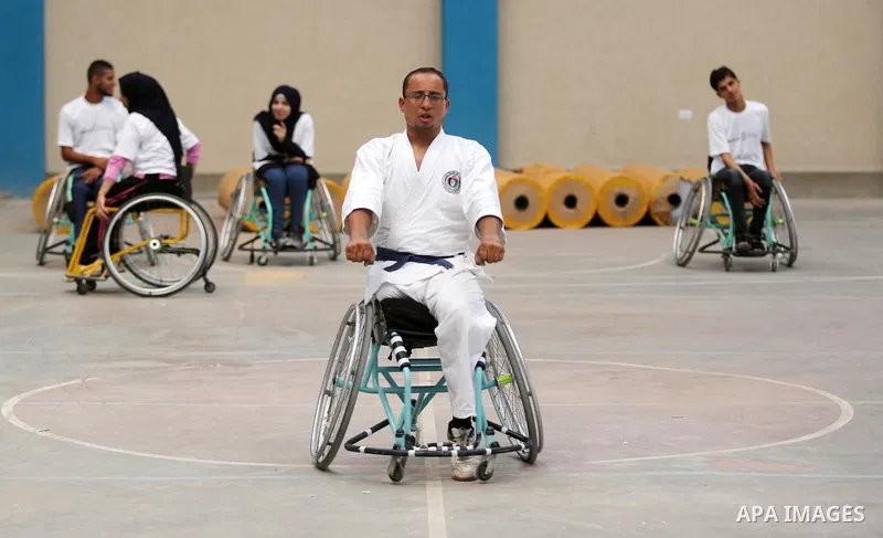 Palestinian handicappeds on wheelchairs take part in a Karate lesson, at a club in Gaza city on September 11, 2018. Photo by Ashraf Amra