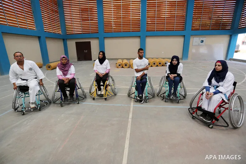 Palestinian handicappeds on wheelchairs take part in a Karate lesson, at a club in Gaza city on September 11, 2018. Photo by Ashraf Amra