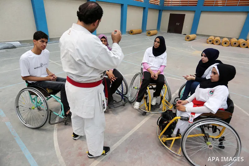 Palestinian handicappeds on wheelchairs take part in a Karate lesson, at a club in Gaza city on September 11, 2018. Photo by Ashraf Amra