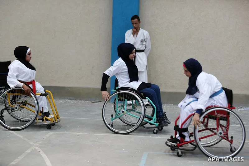 Palestinian handicappeds on wheelchairs take part in a Karate lesson, at a club in Gaza city on September 11, 2018. Photo by Ashraf Amra