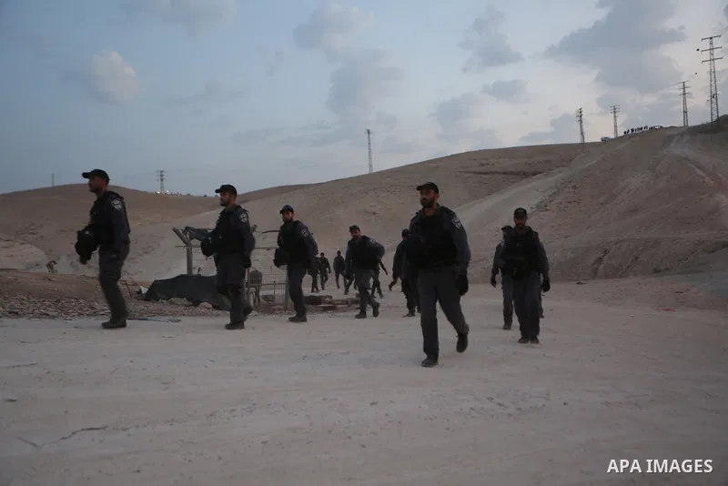 Israeli forces walk after removing shacks which were erected by Palestinian activists to protest against Israel's plan to demolish the Palestinian Bedouin village of Khan al-Ahmar, in Khan al-Ahmar, in the occupied West...