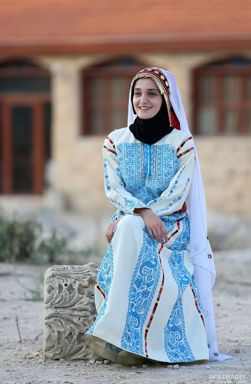 A Palestinian woman wearing traditional dress creation takes part during a Sebastya ninth Festival of Tourism and Heritage, in the West Bank city of Nablus, on September 12, 2018. Photo by Shadi Jarar'ah