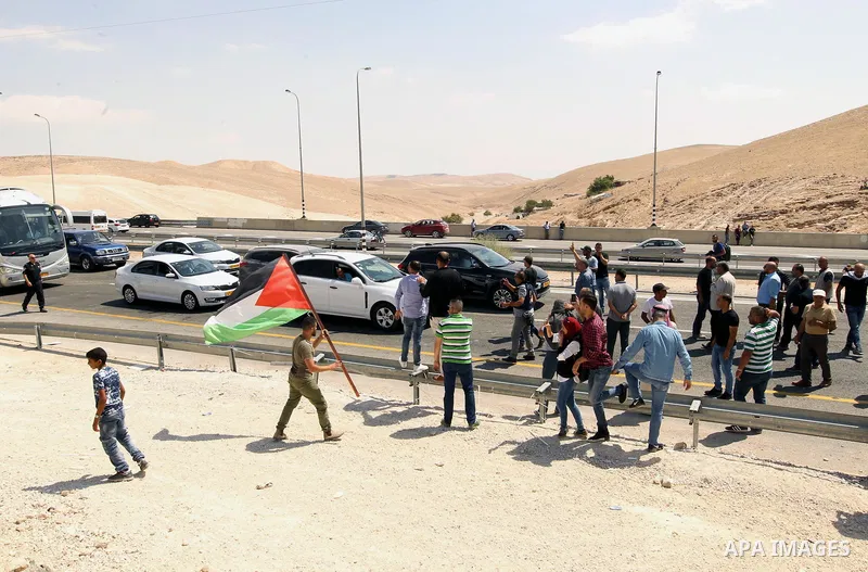 Palestinian protesters take part during a protest against blocking of the road leading to the Palestinian Bedouin village of Khan al-Ahmar by Israeli forces in the occupied West Bank on September 14, 2018. Photo by Wisam...