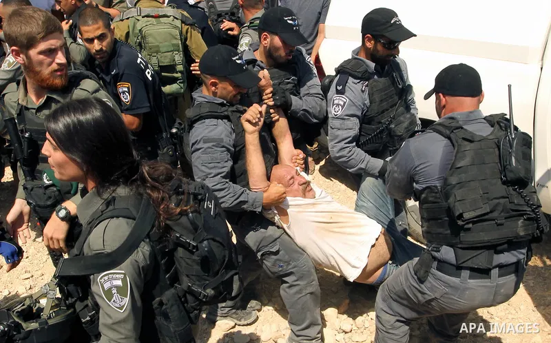 Israeli troops detain a Palestinian protester during a demonstration against the blocking of the road leading to the Palestinian Bedouin village of Khan al-Ahmar in the occupied West Bank on September 14, 2018. Photo by...