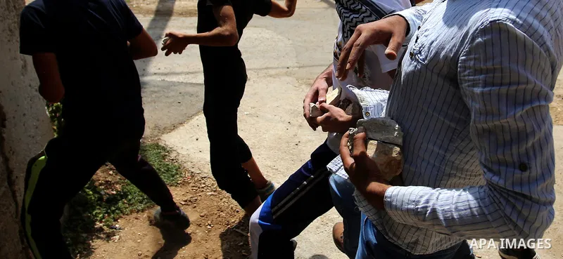 Palestinian protesters hurl stones towards Israeli forces during clashes following a weekly demonstration against the expropriation of Palestinian land by Israel in the village of Kfar Qaddum, near the West Bank city of...
