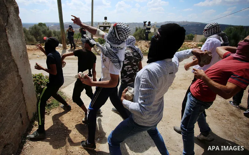 Palestinian protesters hurl stones towards Israeli forces during clashes following a weekly demonstration against the expropriation of Palestinian land by Israel in the village of Kfar Qaddum, near the West Bank city of...