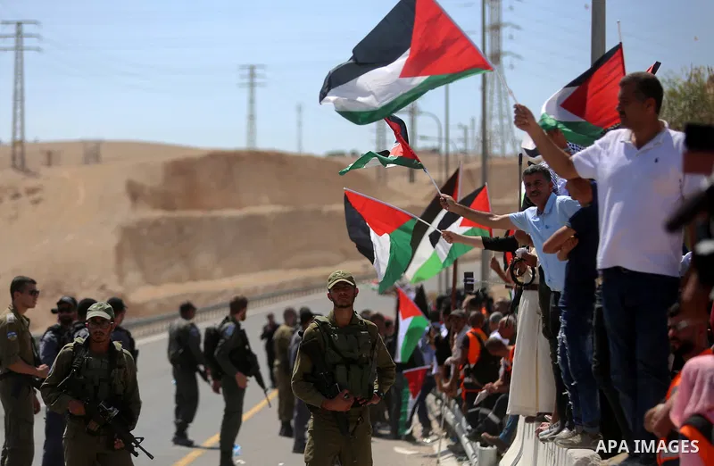 Palestinian protesters take part during a protest against blocking of the road leading to the Palestinian Bedouin village of Khan al-Ahmar by Israeli forces in the occupied West Bank on September 14, 2018. Photo by Shadi...