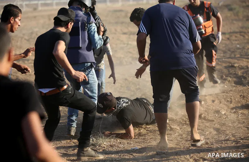 Palestinian protesters gather during clashes with Israeli troops in tents protest where Palestinians demand the right to return to their homeland at the Israel-Gaza border, in east of Gaza city on September 14, 2018. Pho...