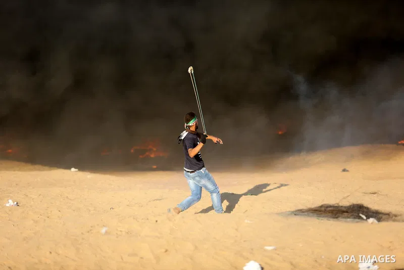 Palestinian protesters gather during clashes with Israeli troops in tents protest where Palestinians demand the right to return to their homeland at the Israel-Gaza border, in Khan Younis in the southern Gaza Strip on Se...