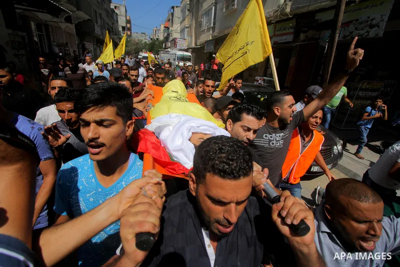 Mourners carry the body Palestinian boy Shady Abdel Aal, 11, who was shot dead by Israeli troops during clashes in tents protest at the Israel-Gaza border, during his funeral in Beit Lahia, in the northern of Gaza Strip...
