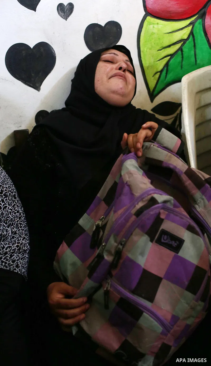 The mother of Palestinian boy Shady Abdel Aal, 11, who was shot dead by Israeli troops during clashes in tents protest at the Israel-Gaza border, mourns during his funeral in Beit Lahia, in the northern of Gaza Strip on...