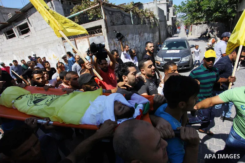 Mourners carry the body Palestinian boy Shady Abdel Aal, 11, who was shot dead by Israeli troops during clashes in tents protest at the Israel-Gaza border, during his funeral in Beit Lahia, in the northern of Gaza Strip...