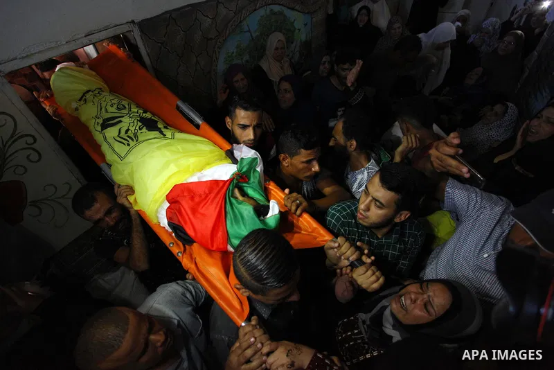 Mourners carry the body Palestinian boy Shady Abdel Aal, 11, who was shot dead by Israeli troops during clashes in tents protest at the Israel-Gaza border, during his funeral in Beit Lahia, in the northern of Gaza Strip...