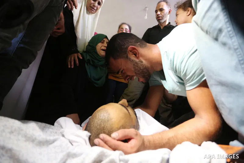 Relatives of Palestinian Mohammed Shaqoura, 21, who was shot dead by Israeli troops during clashes in tents protest at the Israel-Gaza border, mourn next to his body during his funeral in al-Maghazi in the center of Gaza...