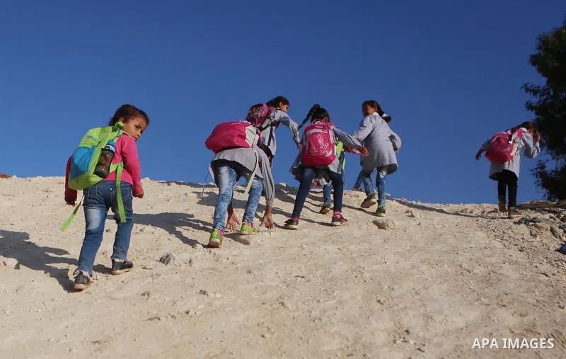 Palestinian Bedouin school children walk in the village of Khan al-Ahmar in the Israeli occupied West Bank on September 16, 2018. Photo by Shadi Hatem