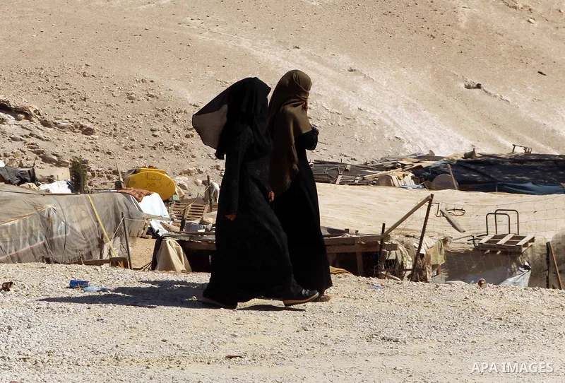 Palestinian Bedouin women walk in the village of Khan al-Ahmar in the Israeli occupied West Bank on September 16, 2018. Photo by Wisam Hashlamoun