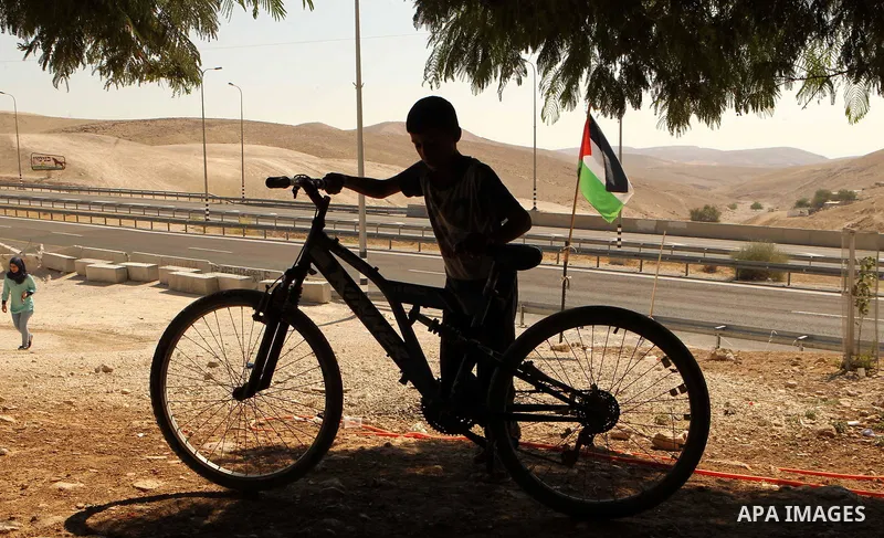 A Palestinian Bedouin school boy walks in the village of Khan al-Ahmar in the Israeli occupied West Bank on September 16, 2018. Photo by Wisam Hashlamoun