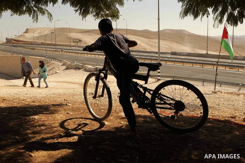 A Palestinian Bedouin school boy walks in the village of Khan al-Ahmar in the Israeli occupied West Bank on September 16, 2018. Photo by Wisam Hashlamoun