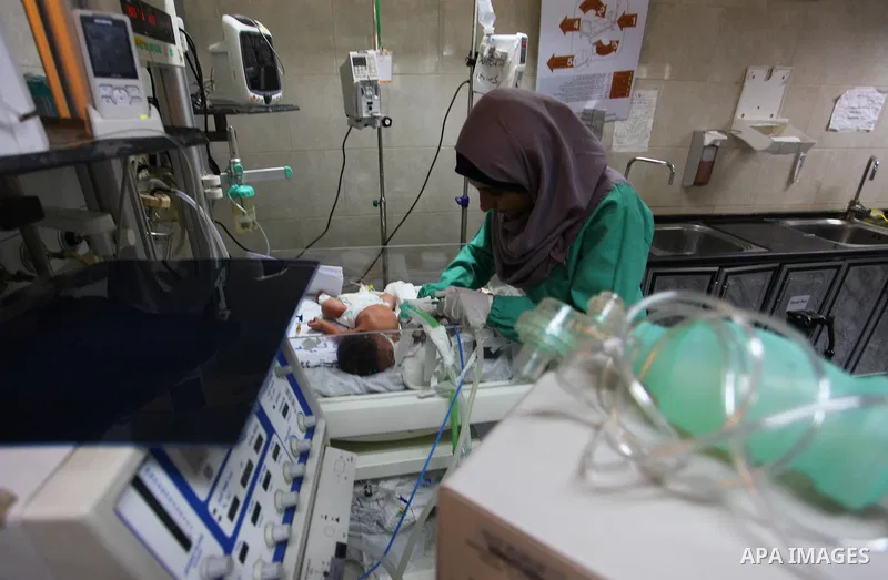A Palestinian nurse checks on a baby in an incubator at the neonatal intensive care unit , at al-Shifa hospital, during the crisis of power outages in the Gaza City, on September 16, 2018. Photo by Mahmoud Ajour