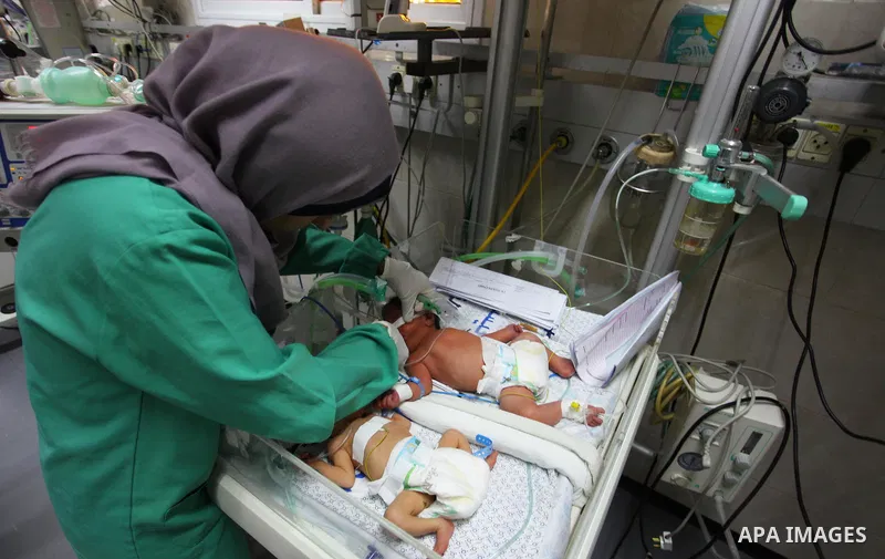 A Palestinian nurse checks on a baby in an incubator at the neonatal intensive care unit , at al-Shifa hospital, during the crisis of power outages in the Gaza City, on September 16, 2018. Photo by Mahmoud Ajour