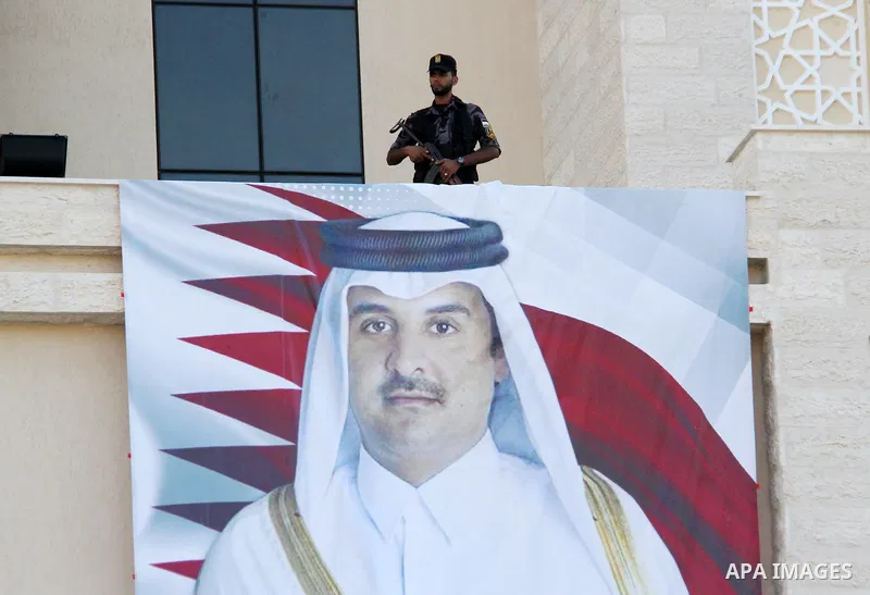 A picture taken on September 16, 2018 shows a poster of Emir of Qatar Sheikh Tamim bin Hamad Al-Thani placed on new headquarters of the superior committee of justice, which was funded by Qatar in south of Gaza City. Phot...