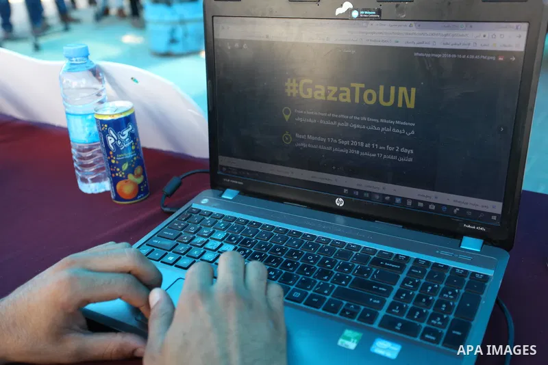 Palestinians take part in the Social Media solidarity Campaign "Gaza Speaks To the UNGA" in front of the headquarter United Nation "UNSCO", in Gaza city on September 17, 2018. Photo by Mahmoud Ajour