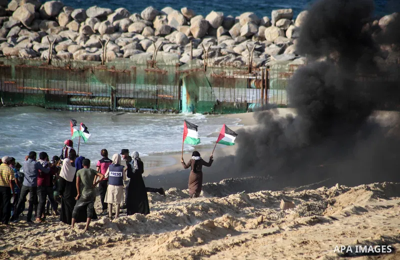 Palestinian protesters gather during clashes with Israeli forces in a demonstration against the Israeli blockade on Gaza Strip, along the Gaza sea barrier on the maritime border with Israel near Kibbutz Zikim, north of B...