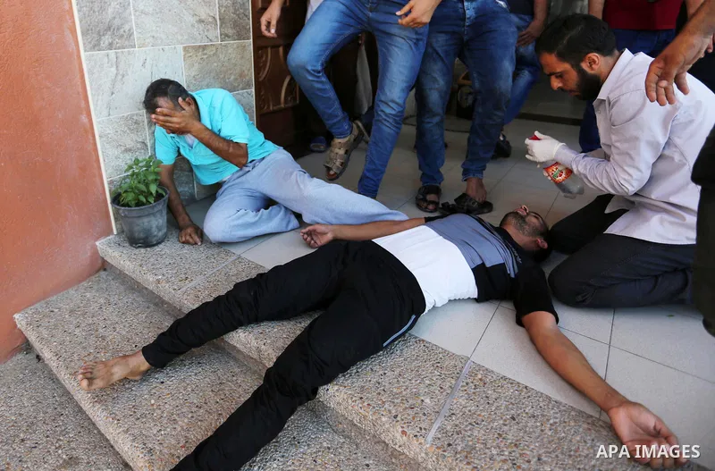 Relatives of two Palestinian men, who were killed in an Israeli air strike at the Israel-Gaza border the night before, mourns outside the hospital, after identifying the bodies in Khan Younis in the southern Gaza Strip o...