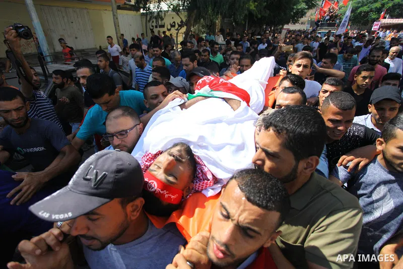 Mourners carry the body of Palestinian Mohamed Abu Nagy who was shot dead by Israeli troops during a demonstration against Israeli blockade on Gaza Strip, at the Erez crossing with Israel during his funeral in Jabalia in...