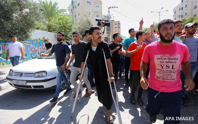 Mourners carry the body of Palestinian Mohamed Abu Nagy who was shot dead by Israeli troops during a demonstration against Israeli blockade on Gaza Strip, at the Erez crossing with Israel during his funeral in Jabalia in...
