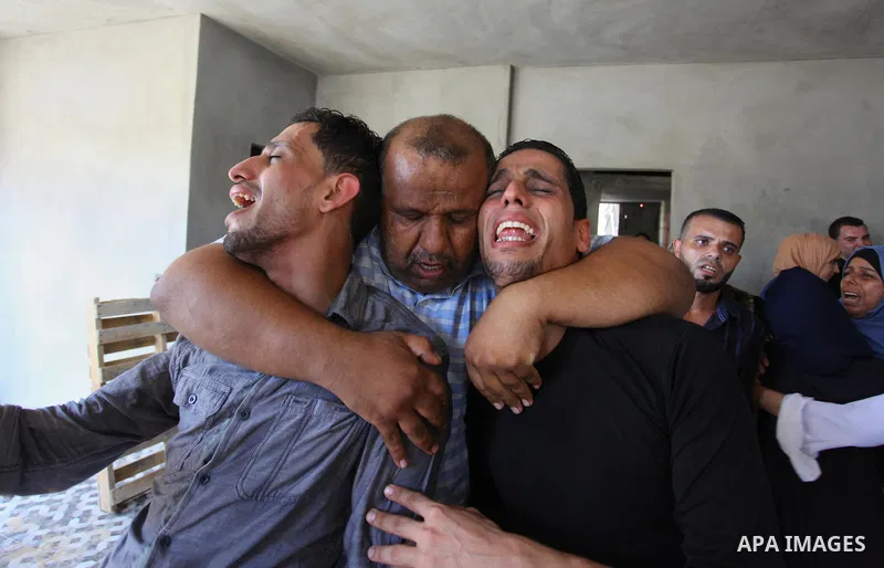 Relatives of Palestinian Ahemd Omar who was shot dead by Israeli troops during a demonstration against Israeli blockade on Gaza Strip, at the Erez crossing with Israel mourn during his funeral at el-Shati refugee camp in...
