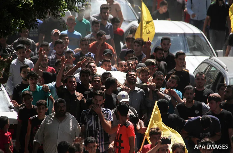 Mourners carry the body of Palestinian Ahemd Omar who was shot dead by Israeli troops during a demonstration against Israeli blockade on Gaza Strip, at the Erez crossing with Israel during his funeral at el-Shati refugee...