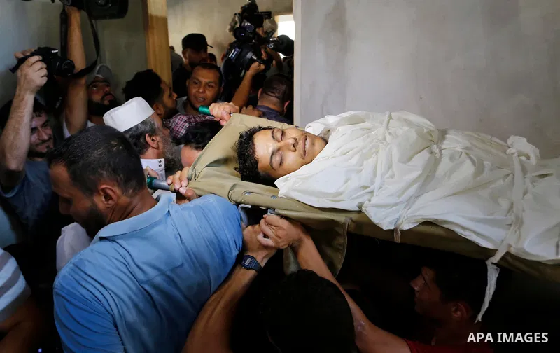 Mourners carry the body of Palestinian Ahemd Omar who was shot dead by Israeli troops during a demonstration against Israeli blockade on Gaza Strip, at the Erez crossing with Israel during his funeral at el-Shati refugee...