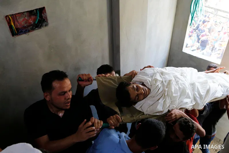 Mourners carry the body of Palestinian Ahemd Omar who was shot dead by Israeli troops during a demonstration against Israeli blockade on Gaza Strip, at the Erez crossing with Israel during his funeral at el-Shati refugee...