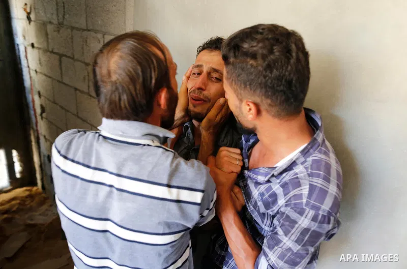 Relatives of Palestinian Ahemd Omar who was shot dead by Israeli troops during a demonstration against Israeli blockade on Gaza Strip, at the Erez crossing with Israel mourn during his funeral at el-Shati refugee camp in...