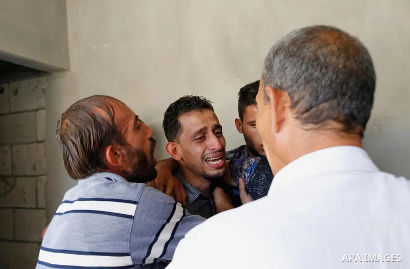 Relatives of Palestinian Ahemd Omar who was shot dead by Israeli troops during a demonstration against Israeli blockade on Gaza Strip, at the Erez crossing with Israel mourn during his funeral at el-Shati refugee camp in...