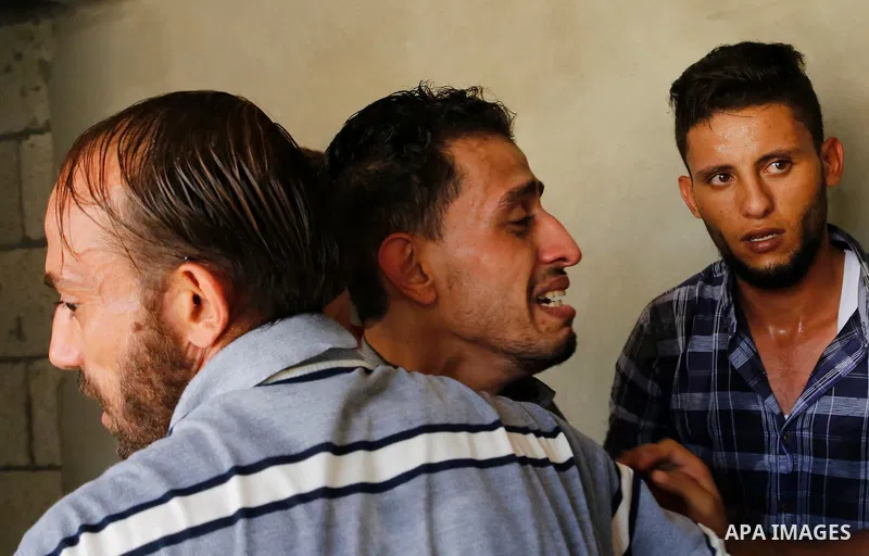 Relatives of Palestinian Ahemd Omar who was shot dead by Israeli troops during a demonstration against Israeli blockade on Gaza Strip, at the Erez crossing with Israel mourn during his funeral at el-Shati refugee camp in...